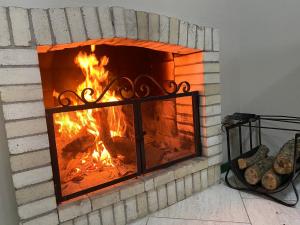 a brick fireplace with a fire in it at Letto Hotel Candeeiro da Serra in São Salvador +28 photos