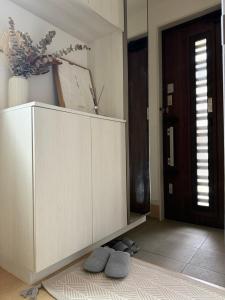 福山市にある一軒家貸切尾道観光 JR松永駅徒歩1分MAX6人 Cozy Entire House Great for Onomichi Sightseeing! 1-Min Walk from JR Matsunaga Station, Free Parking, Sleeps up to 6 Guestsの部屋にある大きな白いキャビネットと2つの灰色の枕