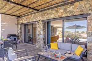 an outdoor patio with a couch and a table at Villa Davia in Corbara