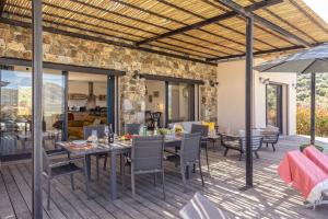 an outdoor patio with a table and chairs at Villa Davia in Corbara