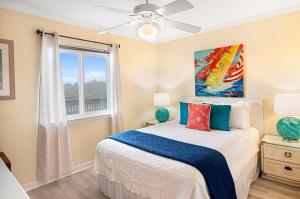 a bedroom with a bed and a window at 33C Lighthouse Point in Tybee Island +31 photos