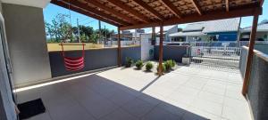 an outdoor patio with awning on a house at Linda Casa de Praia com Piscina em Itapoá in Itapoa