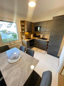 a kitchen with a table with a laptop on it at HarzRoots mit Garage in Bad Harzburg
