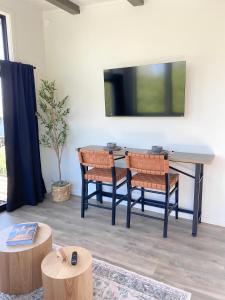 a dining room with a table and chairs and a tv at Romantic Hideout I Bay Access I Near Tidal Falls in Gouldsboro