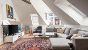 a living room with a couch and a tv at Palads Hotel in Viborg