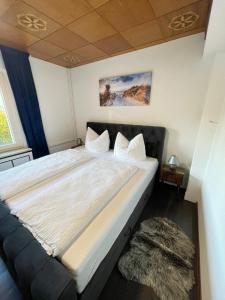 a bedroom with a large bed with a rug at HarzRoots mit Garage in Bad Harzburg +14 photos
