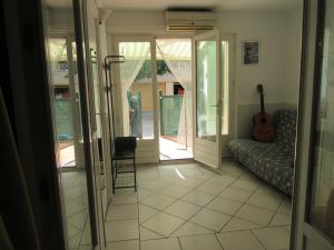 a living room with a couch and a guitar at La Bastide in Sanary-sur-Mer