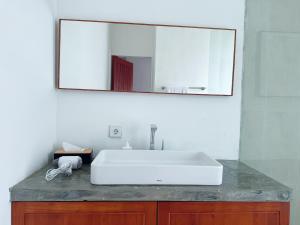 a bathroom with a white sink and a mirror at Villa Leyan 1 Semer - Between Seminyak & Canggu in Seminyak +14 photos