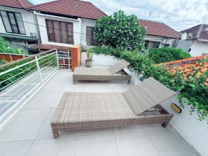 a patio with two chairs and a table at Villa Leyan 1 Semer - Between Seminyak & Canggu in Seminyak