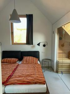 a bedroom with a bed and a window and a shower at Architect's House With Nature View 