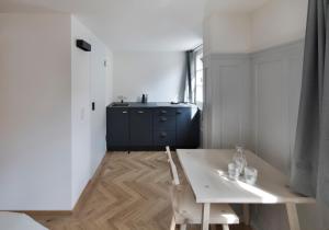 a room with a white table and a blue cabinet at Krone Hard - self check-in in Hard