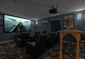 a waiting room with chairs and a large screen at Blue Moon - LUX Oceanfront Pool Hot Tub Theater in Waves