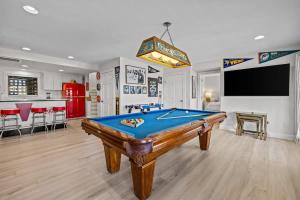 a living room with a pool table in it at Blue Moon - LUX Oceanfront Pool Hot Tub Theater in Waves