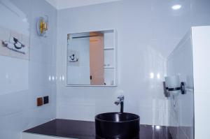 a bathroom with a sink and a mirror at Daisy Apptment in Malindi +15 photos