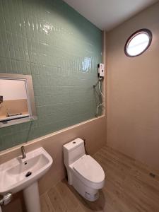 a bathroom with a toilet and a sink and a mirror at สุขใจ โฮม Minimal Apartment ใกล้ Central นครปฐม แอร์เย็นฉ่ำๆ in Nakhon Pathom +14 photos