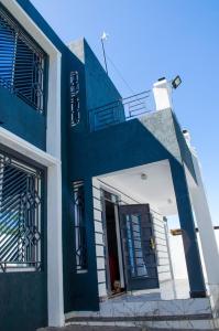 a blue and white building with a blue door at Daisy Apptment in Malindi