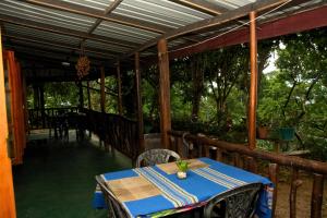 a table on a porch with a blue table cloth at Bliss In Viya in Ella