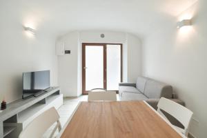 a living room with a table and a couch at AM8 - Cozy apartment in the center in Perugia