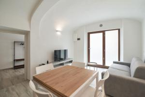 a living room with a table and a couch at AM8 - Cozy apartment in the center in Perugia