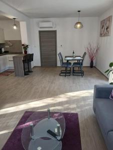 a living room with a couch and a table at Apartman Lasko in Razvala +5 photos