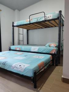 two bunk beds sitting next to each other in a room at Casa Vacacional - Portales del Sol 2 in Tocaima +29 photos