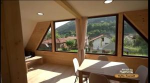 a view from the dining room of a house with large windows at Kuca Rancic in Pirot