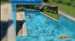 two people swimming in a swimming pool at Kuca Rancic in Pirot