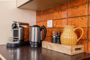eine Küchentheke mit Kaffeemaschine und Vase in der Unterkunft Mätzwiesen Höckli - CharmingStay in Flumserberg