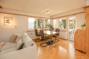 a living room with a couch and a table at Mätzwiesen Höckli - CharmingStay in Flumserberg