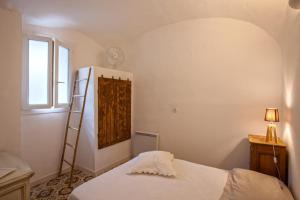 a bedroom with a bed and a ladder and a window at Casa Rione in Omessa