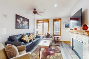 a living room with a couch and a fireplace at Main Street Station #2302 in Breckenridge