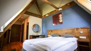 una camera con un grande letto e una parete blu di Hotel Kaiserhof ad Anif Altre 37 foto