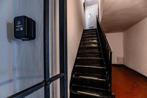 a staircase in a building with a sign on the wall at Historic Palace Duplex - Cruises 2min - AC - WiFi in Savona