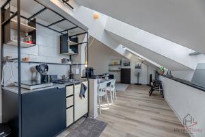 a kitchen and dining room with a staircase in a loft at Historic Palace Duplex - Cruises 2min - AC - WiFi in Savona