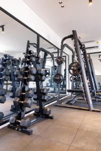 a gym with several rows of tread machines at Bluewaters, Labone in Accra