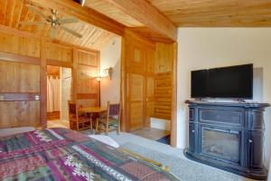 a bedroom with a fireplace and a flat screen tv at Walk to Lava Hot Springs Pools from Cozy Cabin! in Lava Hot Springs
