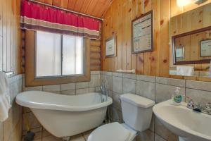 a bathroom with a tub and a toilet and a sink at Walk to Lava Hot Springs Pools from Cozy Cabin! in Lava Hot Springs +19 photos
