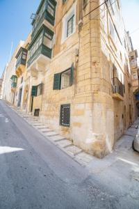 a brick building on the side of a street at Carmelita in Valletta
