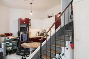 a kitchen with a staircase and a table in a room at Ideal stay in Puteaux with private courtyard in Puteaux