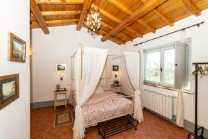 a bedroom with a canopy bed and a window at Agriturismo Specchio Del Lago in Montefiascone +171 photos