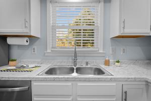 a kitchen counter with a sink and a window at Pet-Friendly 3 BR Home with King Bed and Fenced Yard Near Downtown in New Bern +23 photos