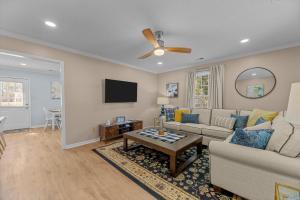 a living room with a couch and a table at Pet-Friendly 3 BR Home with King Bed and Fenced Yard Near Downtown in New Bern