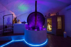 a room with a bathtub with purple and blue lights at Grotta azzurra - Suite e spa in Monticelli