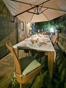 a table with an umbrella on a patio at Small Castle With Sea View In Campiglia Marittima in Campiglia Marittima