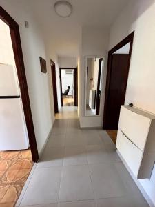 a hallway of a house with white walls and doors at Holiday Vintage Apartment in San Pedro del Pinatar