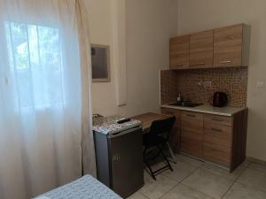 a small kitchen with a small table and a counter top at Ζ&Ζ Studios in Perea