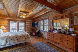 a bedroom with a bed in a wooden cabin at Daniel Boone Lodge in Boone