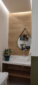 a bathroom with a sink and a mirror at Studio 101 Cop 30 in Belém