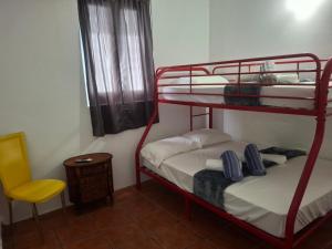 a room with two bunk beds and a yellow chair at Hacienda El Palmar A in Vega Baja +12 photos