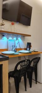 a desk with two chairs and a computer on it at Studio 101 Cop 30 in Belém +10 photos